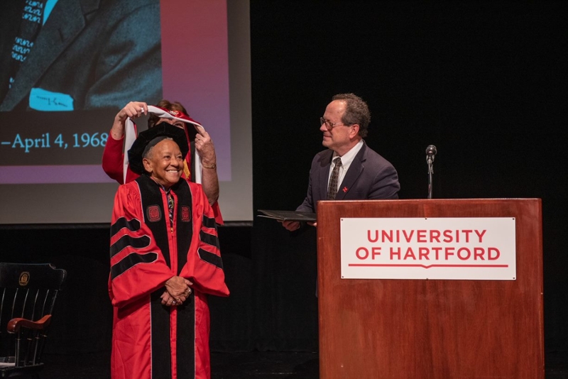 photo of giovanni being hooded by Pat McKinley and Greg Woodward